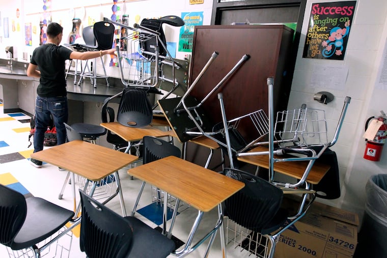 FILE - In this Jan. 22, 2013, file photo, a student helps block the classroom door with furniture during a mock lockdown drill at Moody High School in Corpus Christi, Texas. (Rachel Denny Clow/Corpus Christi Caller-Times via AP, File)