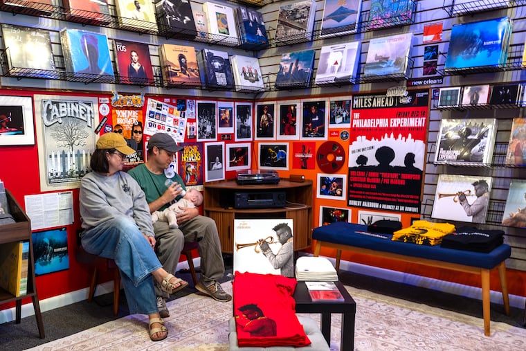 Owners Samantha and Joseph Mallah and their 2-month-old son Elliot at the Vintage Future Now shop in Collingswood on Sept. 30.