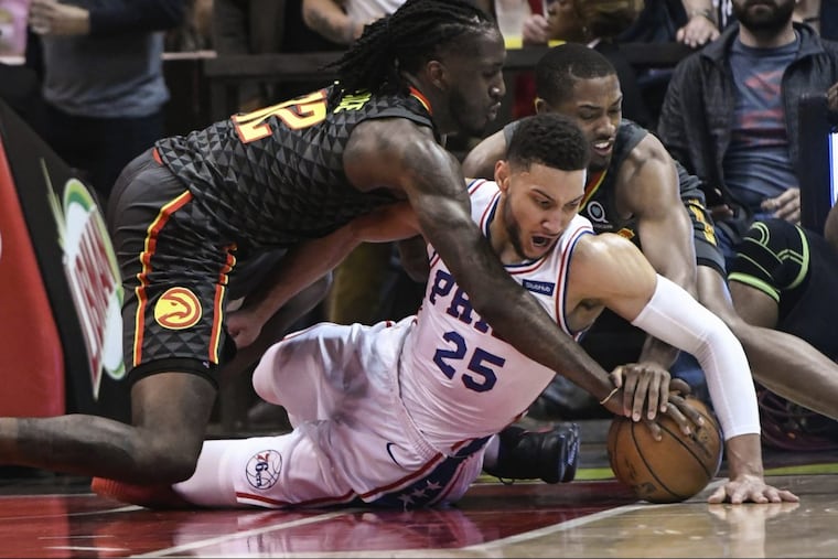 Sixers guard Ben Simmons (25) and Atlanta’s Taurean Prince (left) and Isaiah Taylor vie for a loose ball during the Sixers' win in Atlanta on Tuesday.