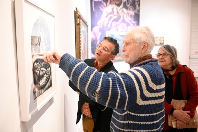 Michael Biddle and Bill Valerio look at art works by George Biddle at an exhibition of his work at the Woodmere Art Museum in Philadelphia. They're accompanied by sculptor, and Biddle's wife, Elizabeth Surbeck Biddle. On December 16, 2022. BASTIAAN SLABBERS / For the Inquirer