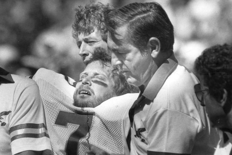 Ron Jaworski is carried off the field during a 1983 game after one of the many big hits he absorbed during a 17-year NFL career. (TOM GRALISH / STAFF PHOTOGRAPHER)