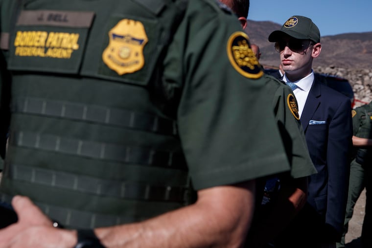 White House senior adviser Stephen Miller watches as President Donald Trump tours a section of the southern border wall, Wednesday, Sept. 18, 2019, in Otay Mesa, Calif. (AP Photo/Evan Vucci)