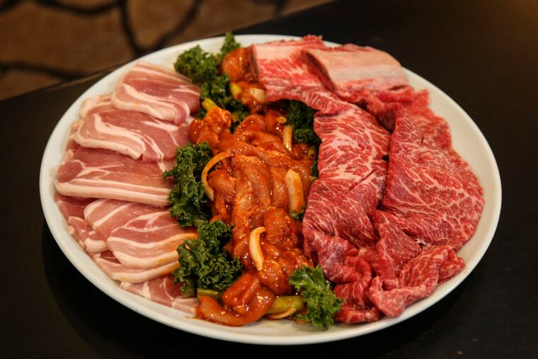 At Seorabol in Olney, a combo platter with marinated galbi beef short ribs, pork belly, and spicy chicken is shown in 2018.