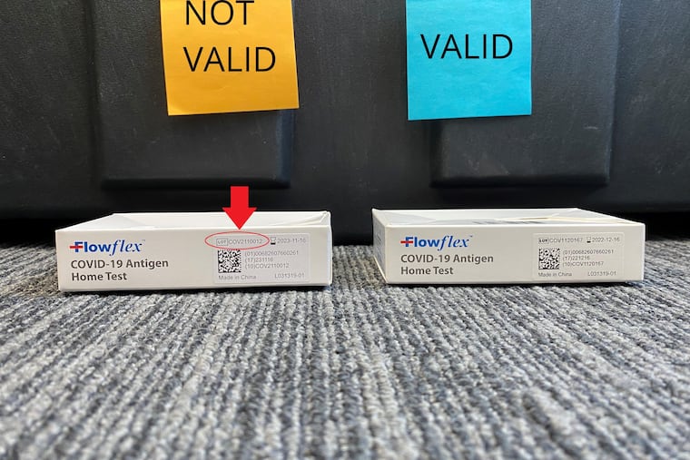 An invalid Flowflex COVID-19 rapid test, with a false lot number, is shown next to a valid test. Philadelphia's health department is recalling thousands of the invalid tests after discovering they were not made by Flowflex's manufacturer.
