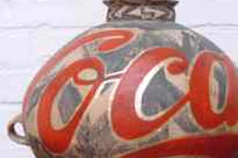A vase decorated with a red swirl of Coca-Cola script, is part of the Ai Weiwei show at the Arcadia University gallery.