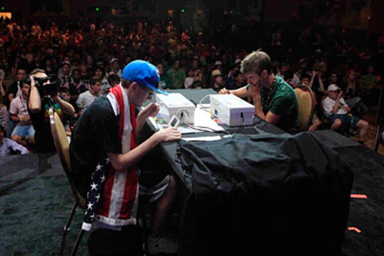 A flag-draped Ray Rizzo competes in the Pokémon World Championships. "Chess is a good comparison," said the company's marketing chief. "Except Pokémon is more complex."