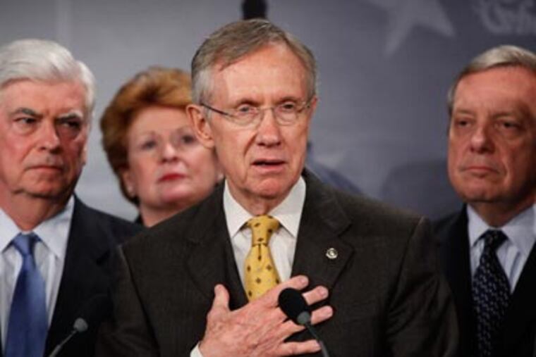 Senate Majority Leader Sen. Harry Reid, D-Nev., second right, with Sens. Chris Dodd, D-Conn., left, Debbie Stabenow, D-Mich., second left, and Dick Durbin, D-Ill., right, speaks to the media about the Democratic health care bill. (AP Photo/Manuel Balce Ceneta)