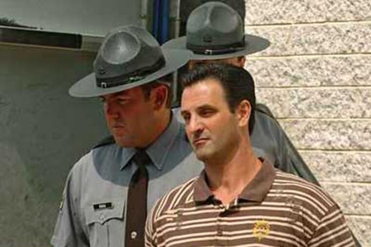 Alleged mob ringleader Louis "Bent Finger Lou" Monacelloin July, 2008 file photo, being led by State Troopers from the State Police Barracks in Media. (Photo by Clem Murray / Inquirer)