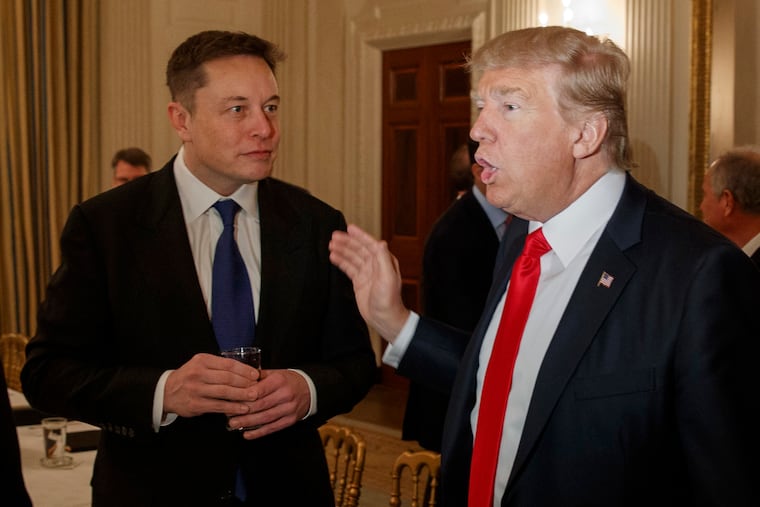 Former President Donald Trump, right, talks with Tesla and SpaceX CEO Elon Musk at the White House in this 2017 file photo. Musk has endorsed Trump's 2024 run for the presidency.