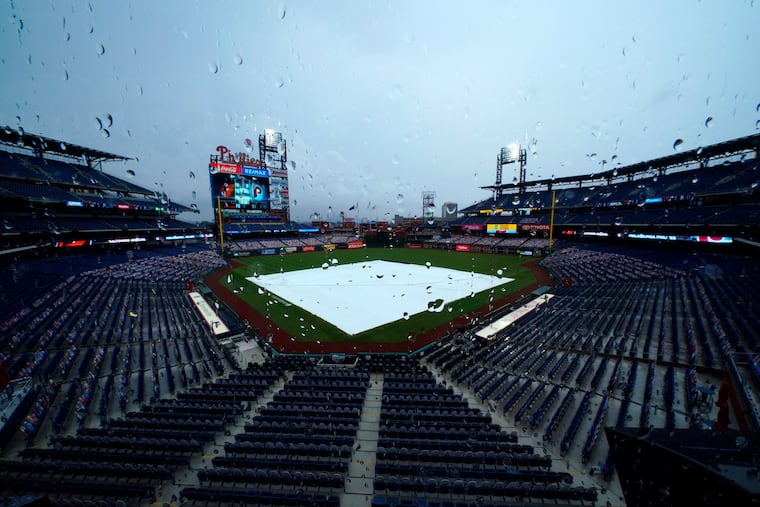 A tarp covers the field at Citizens Bank Park as rain delays the start of a game between the Phillies and Orioles in 2020.