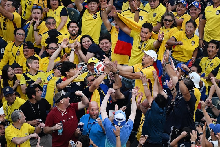 Fans reach for a ball that entered the stands during a FIFA World Cup Group E match between Ecuador and Ivory Coast on June 14, 2026, at Lincoln Financial Field. The match marked the first FIFA World Cup game played in Philadelphia.