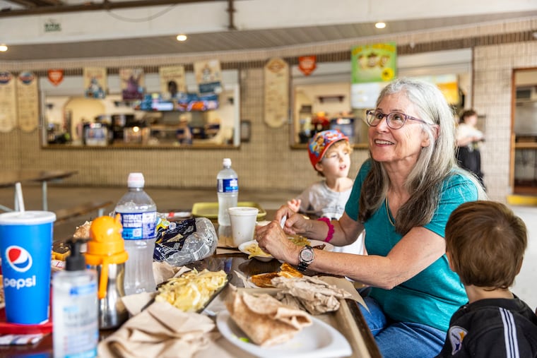 Patricia Buriak, of Bucks County, Pa., is eating lunch with her family at the at the International Food Court at Knoebels Amusement Resort in Elysburg, Pa.