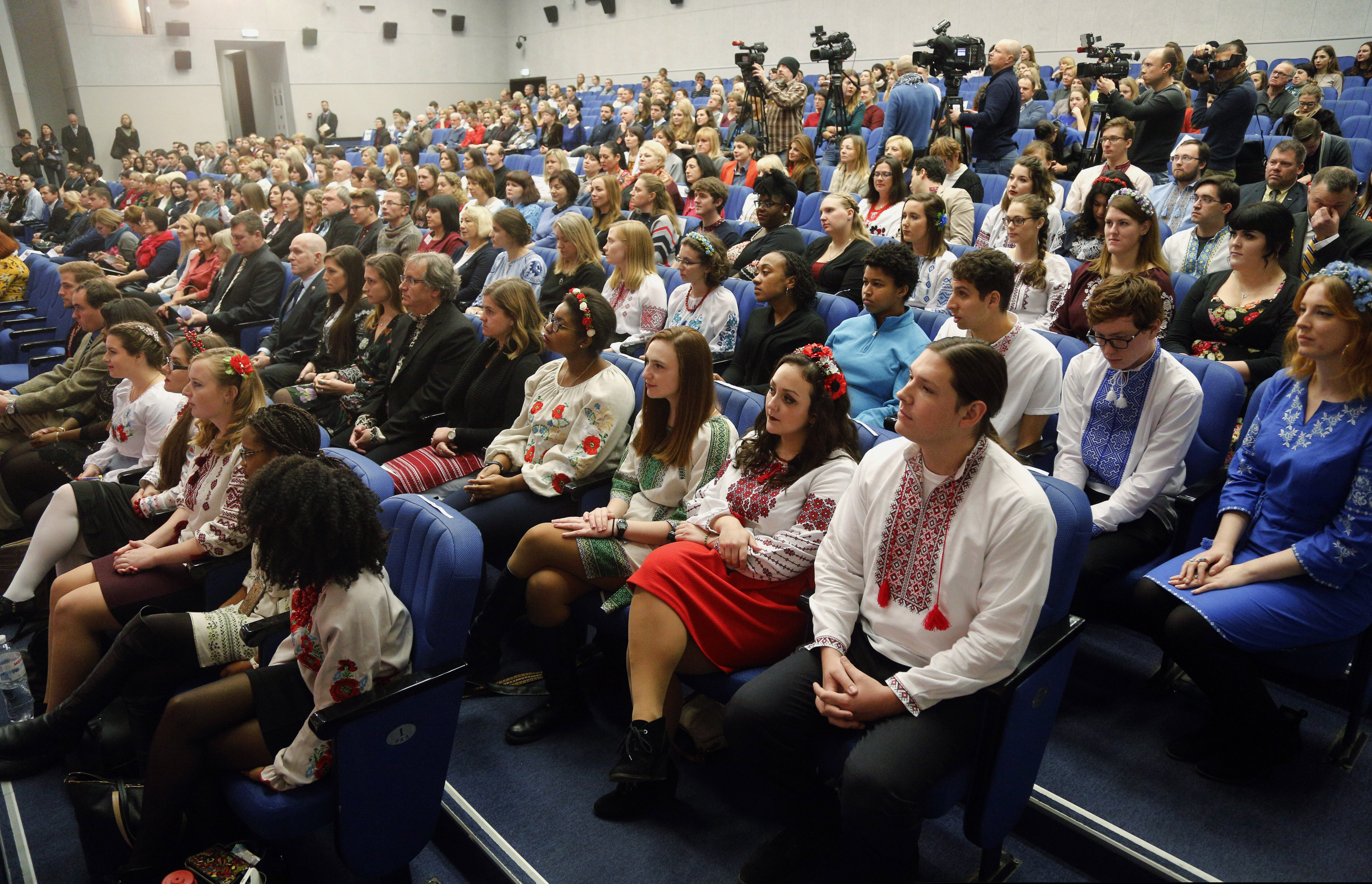 In this Nov. 30, 2017, file photo, volunteers of U.S. Peace Corps wearing Ukrainian national costumes attend a ceremony as they swear an oath of allegiance in Kiev, Ukraine. The Peace Corps is telling its volunteers around the world that it is suspending all operations globally and evacuating all volunteers.