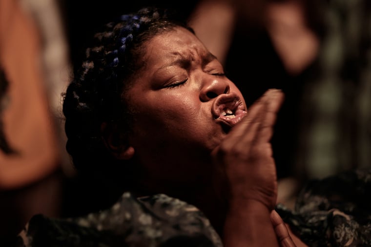 Artist Vanessa German performs while introducing her exhibit “The House, The Oracle, and The Table" at The Colored Girls Museum in Philadelphia.