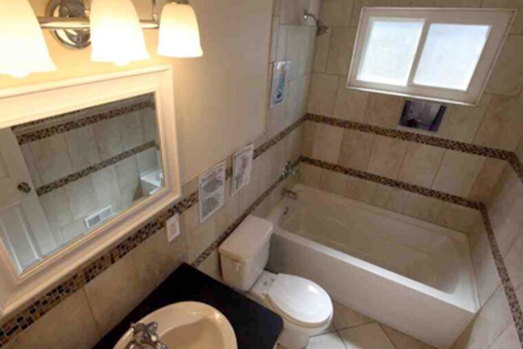 A refurbished Habitat for Humanity home in Sterling Heights, Mich., features green technology, including a dual-flush toilet. (Brian Kaufman / Detroit Free Press)