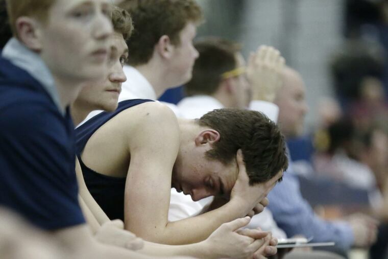 Shawnee’s Kane Feudtner rests his head in his hands briefly after coming out of the game late in Shawnee’s loss to Don Bosco prep.