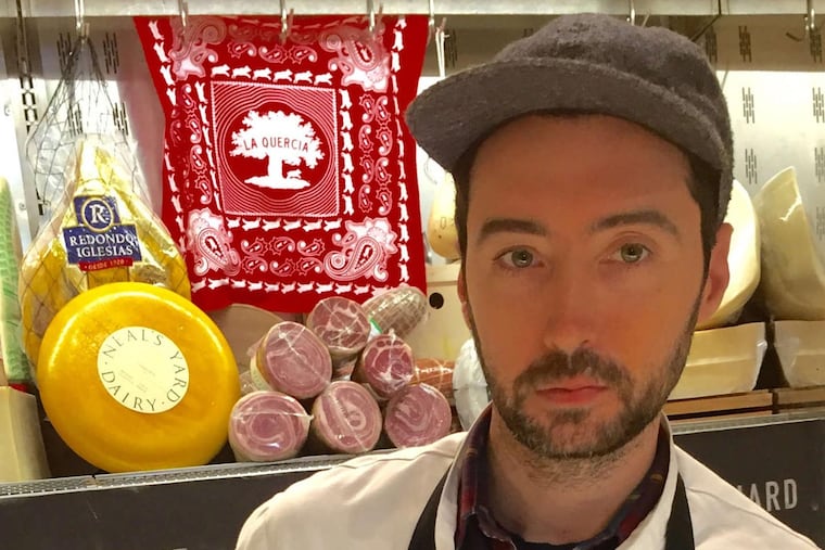 DiBruno's cheese monger Malachy Egan holds a basket of fine, salted French butter from Le Meunier.