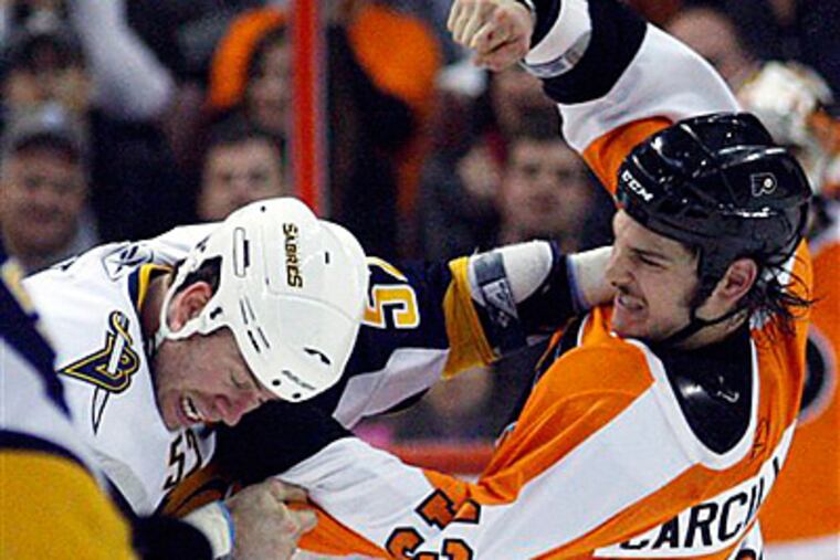 Buffalo Sabres' Craig Rivet, left, and Philadelphia Flyers' Daniel Carcillo fight in the second period. (AP Photo/Matt Slocum)