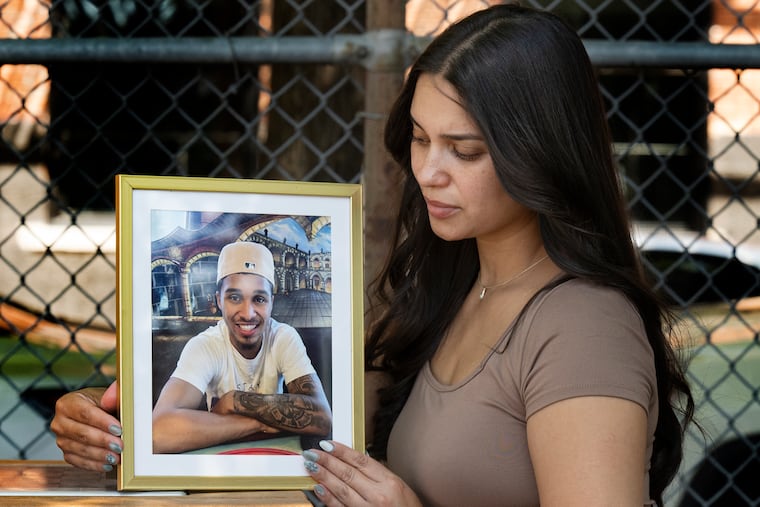 Emelissa Gonzalez holds a portrait of her late son, Jadin Aviles, at Towey Playground near her home.