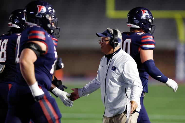 Penn head coach Ray Priore, center, and the Quakers look to end their season on a high note with a road win against Princeton on Saturday.