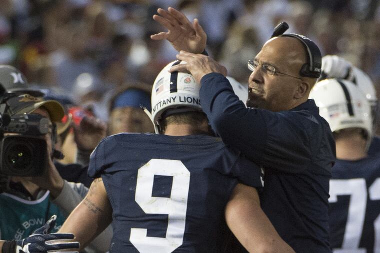 Penn State head coach James Franklin congratulates quarterback Trace McSorley after he scored a touchdown in the 3rd quarter of the 103rd Rose Bowl Game January 2, 2017. USC beat Penn State 52-49 on a last second field goal.