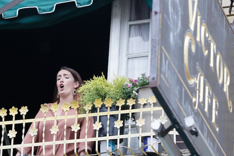 Bartender and server Caitlin Powell sings an aria from "Samson and Delilah" at Victor Cafe in South Philadelphia.