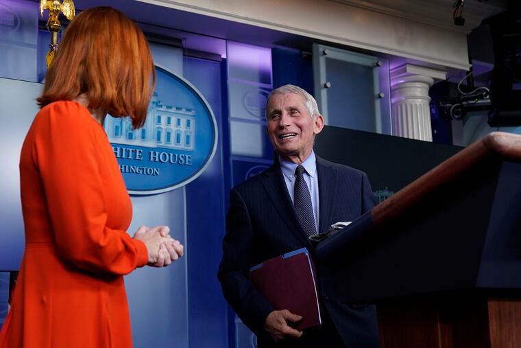 White House press secretary Jen Psaki (left) speaks with Dr. Anthony Fauci, director of the National Institute of Allergy and Infectious Diseases, during a press briefing on Thursday.