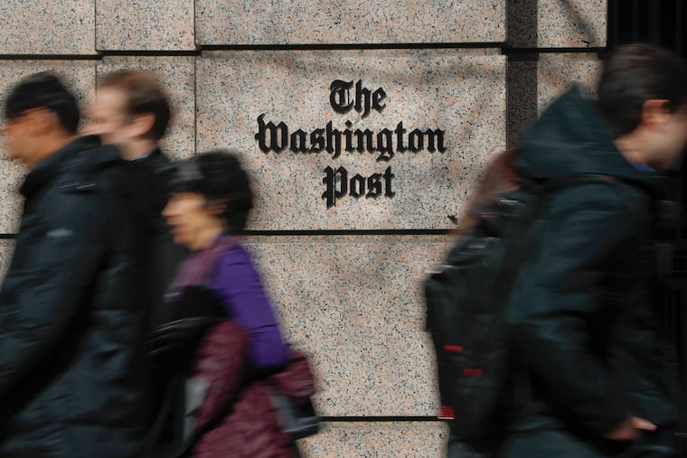 People walk by the One Franklin Square Building, home of The Washington Post newspaper, in downtown Washington, D.C., on Feb. 21, 2019.