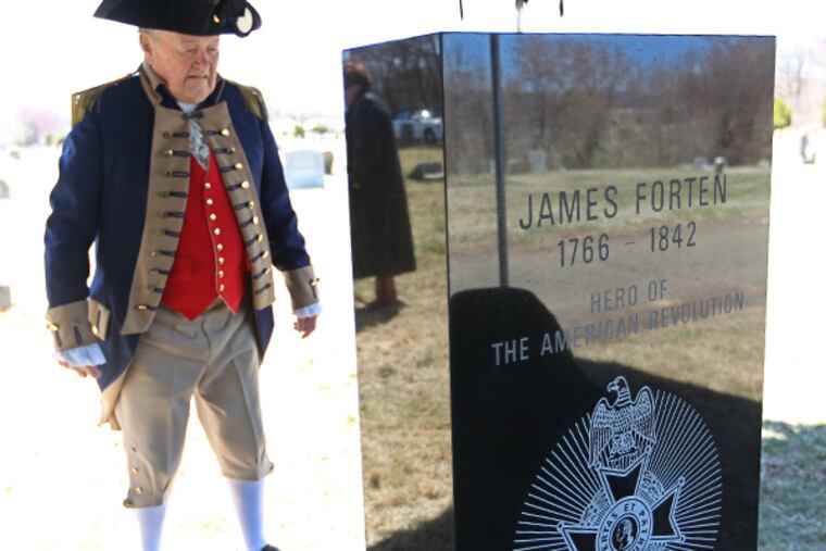 Jim Willis, captain of the Color Guard for the Philadelphia Continental Chapter of the Sons of the American Revolution, takes a good long look at the headstone honoring James Forten before the ceremony honoring his service in the American Revolution at the Eden Cemetery in Collingdale, Pennsylvania. (MICHAEL BRYANT/Staff Photographer)