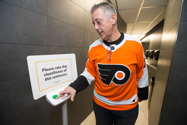 Wells Faro Center is the first NBA/NHL arena to install "HappyOrNot" feedback terminals that allow fans to instantly communicate their satisfaction (or lack thereof) with the arena's bathrooms and concessions. Franco Sicilia gives a men's room a high rating before a Flyers and Rangers pre-season game at the Wells Fargo Center on Sept. 27, 2018. CHARLES FOX / Staff Photographer