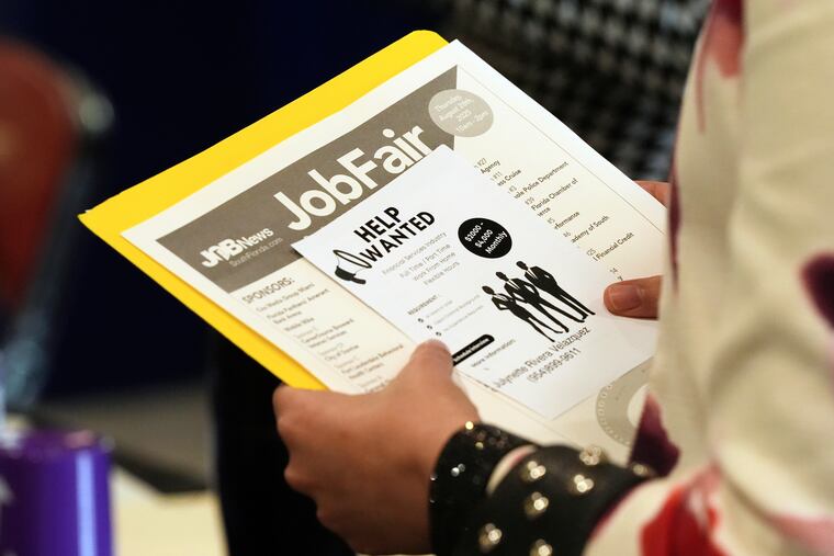 A job seeker waits to talk to a recruiter at a job fair Aug. 28, 2025, in Sunrise, Fla.