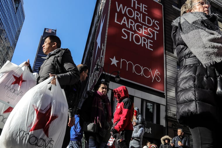 A shopper leaves Macy's department store with bags in both hands during 2019 Black Friday shopping in New York. This year, the unknowns abound. By kicking off sales in October, retailers are hoping to get a jump on demand and make the process safer.