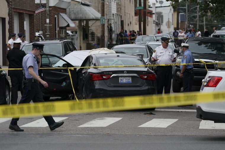 Investigators gather at the crime scene on Hegerman Street near Princeton Avenue in the Tacony section of Philadelpia, Monday Aug. 20, 2018, after police fatal shot a man.