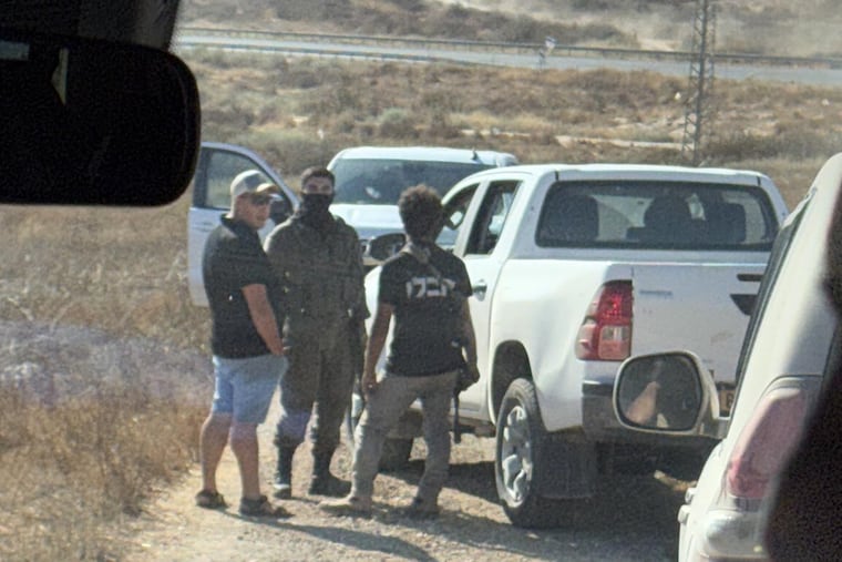 In this photo provided by Cameron Kasky, armed men block the road, stopping vehicles containing U.S. Rep. Ro Khanna (D.,Calif.) and his delegation near the West Bank village of Khirbet Zanuta, Wednesday, July 8, 2026.