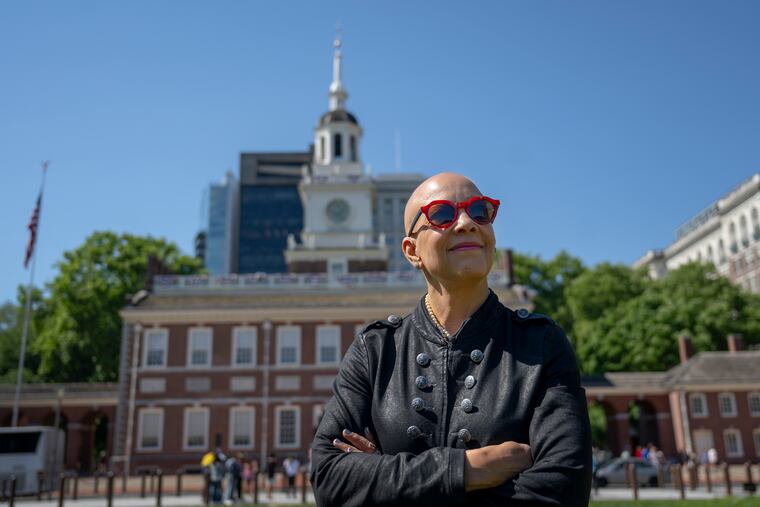 Interior designer Sheila Bridges poses for a portrait near Independence Mall in Philadelphia on Monday. Bridges, a West Philadelphia native known for her iconic Harlem Toile de Jouy pattern, she has launched The Philadelphia Collection, a line of entertaining essentials including cake stands, oven mitts, placemats, pitchers, serving trays, platters, plates, tumblers and ice buckets designed for picnics, backyard barbecues, porch dinners and poolside gatherings.