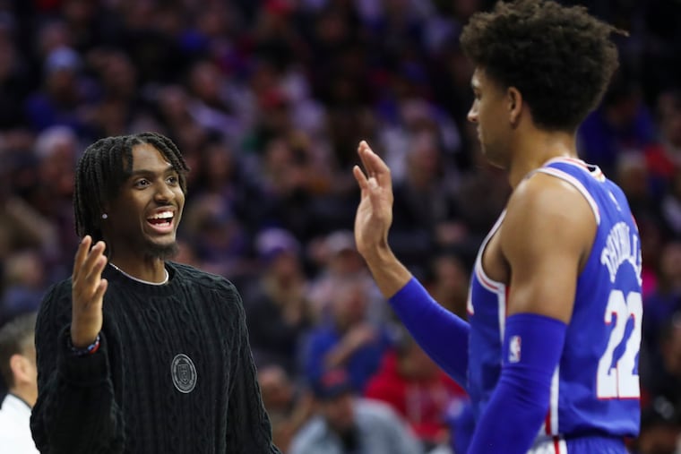 Tyrese Maxey high-fives Matisse Thybulle during a victory against the Detroit Pistons at the Wells Fargo Center last week.