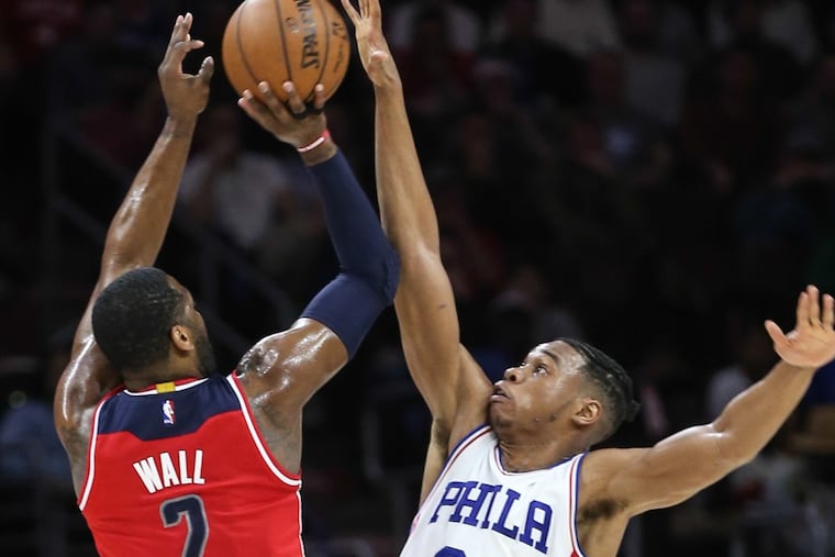 Richaun Holmes of the Sixers blocks the shot of Washington’s John Wall during their game on Feb. 24 last season.