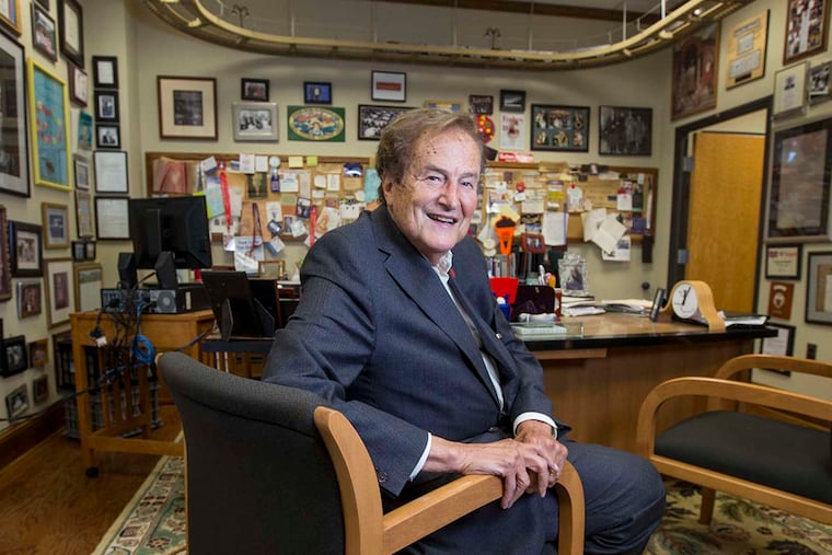 Norman Cohn in his office, which includes a train track suspended from the ceiling. At home, his wife keeps his love for clutter in check.