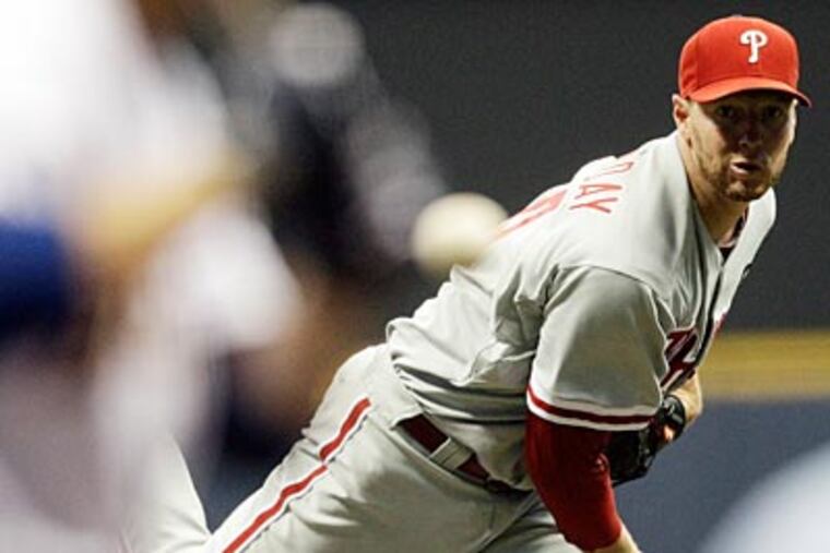 Roy Halladay pitched eight innings, allowed one run and struck out nine in his 17th win of the season. (Morry Gash/AP)