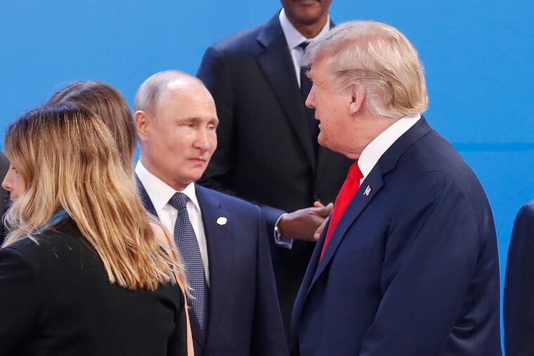 FILE - In this Nov. 30, 2018, file photo, President Donald Trump, right, walk past Russia's President Vladimir Putin, left, as they gather for the group photo at the start of the G20 summit in Buenos Aires, Argentina. The pullout of U.S. troops from Syria ordered by President Donald Trump could further bolster Moscow’s clout in Syria, but it may also destabilise Russia's standing in the region. ( (AP Photo/Pablo Martinez Monsivais, File)