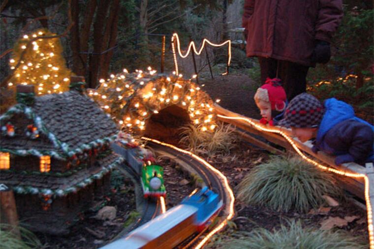 Jimmy Reath (left), Hooper Murphy take in 's Holiday Garden Railway, which lights up this Friday and next. Morris Arboretum