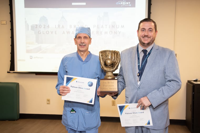 John Paoletti (left), coordinator of patient care services for the cardiac cath lab at Jefferson Torresdale Hospital and Bob Mayer, a senior manager of regional operations and supply chain management for Jefferson, receive an award for reporting and investigating a problem with an IV needle.