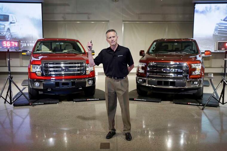 Ford Truck Group marketing manager Doug Scott stands between a 2014 Ford F-150 truck (left) and the new aluminum-sided 2015 F-150, both on scales, at the company's Development Center in Dearborn, Mich. The weight difference between the two vehicles is 732 pounds. Ford said its new F-150 will come with less standard horsepower and torque than traditional pickups, but drivers won't miss it. The new F-150 will start with a 3.5-liter V-6 engine that delivers 283 horsepower and 255 pound-feet of torque, Ford said.