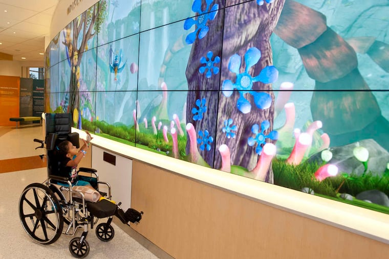 Aaliyah Alley, 4, checks out an interactive display screen at Nemours Children's Hospital in 2019.