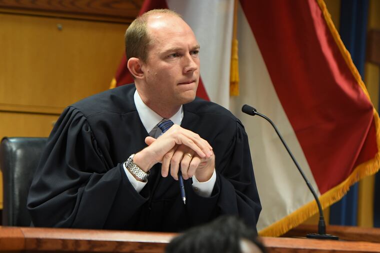 Judge Scott McAfee addresses the lawyers during a hearing on charges against former President Donald Trump in the Georgia election interference case in Atlanta.