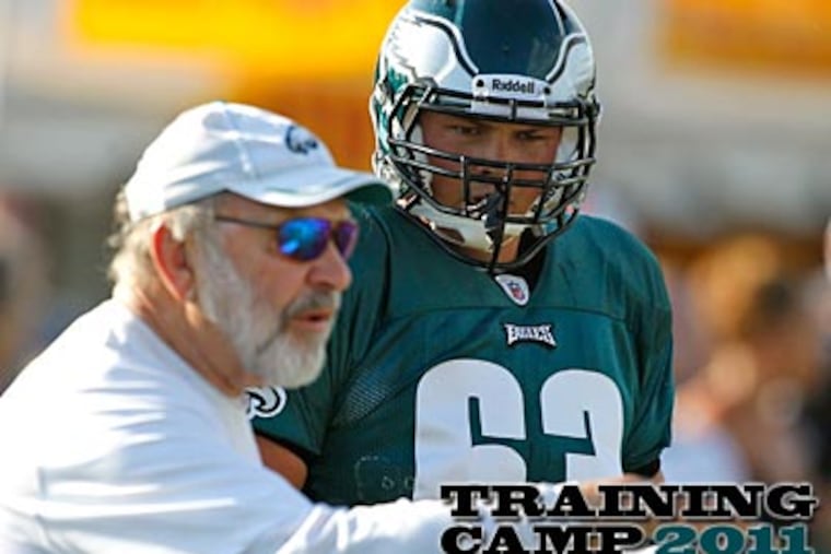 Eagles first-round pick Danny Watkins listens to offensive line coach Howard Mudd at training camp on Wednesday. (Alex Brandon/AP)