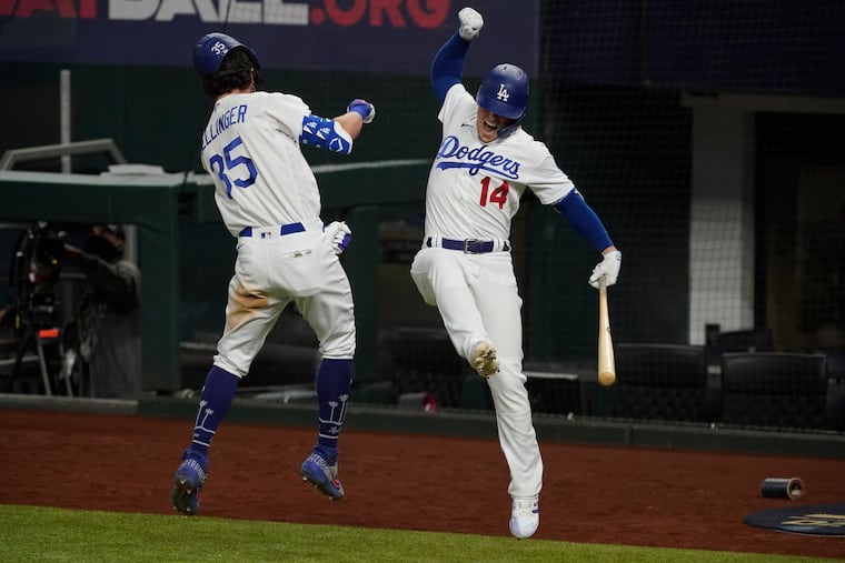 The Dodgers' Cody Bellinger celebrates his tie-breaking home run with Enrique Hernandez.