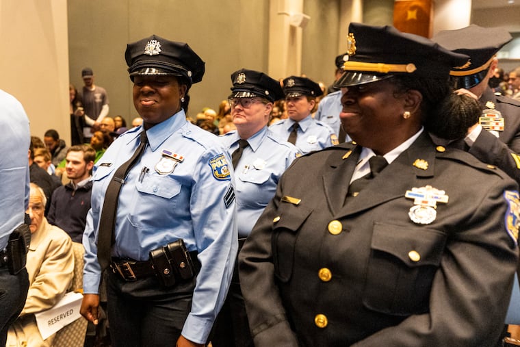 Philadelphia Police Officer Dakieta Long (left), who was promoted to corporal, waits for her name to be called as she looks over to her mom, Stacie Smith, who was promoted to lieutenant, at the Pennsylvania Convention Center in Philadelphia on Wednesday, Nov. 22, 2023.