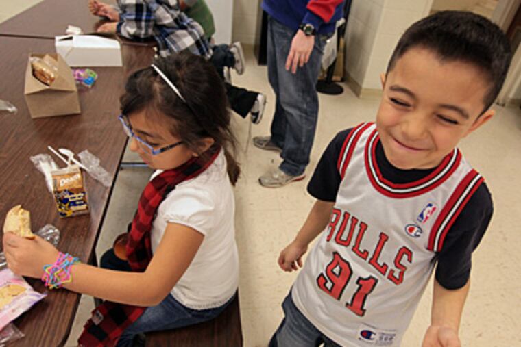 File photo: First-grade Brady Elementary School students Wendy Sanchez, left, and Andrick Mondragon enjoy an afternoon meal at their Aurora, Illinois school in 2011. (MCT)