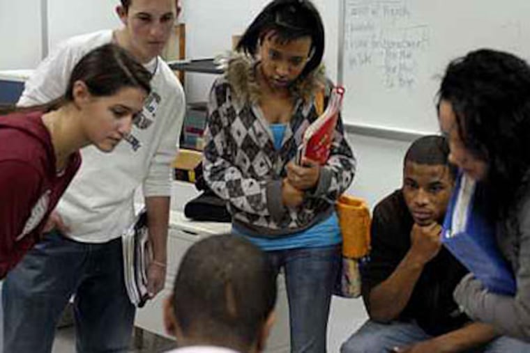 Students gathered around a teen speaker at Pottstown High School after a presentation last month. ( Tom Gralish / Staff Photographer )